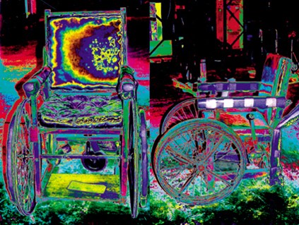 Front and side view of a wheelchair. The wheelchair and its background blend together in a series of vibrant rainbow colors.